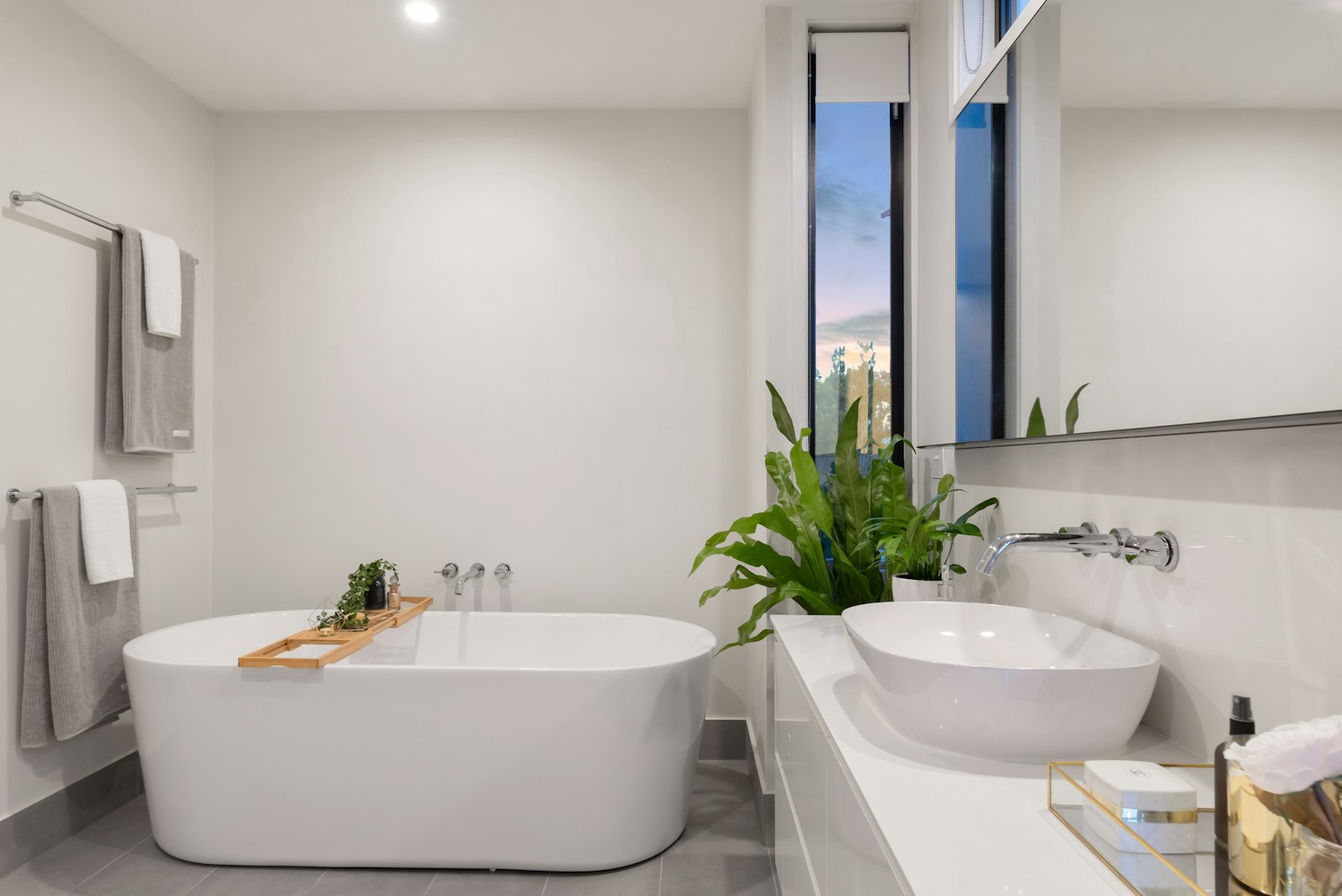 A finished bathroom remodel with a freestanding tub and tiled floor